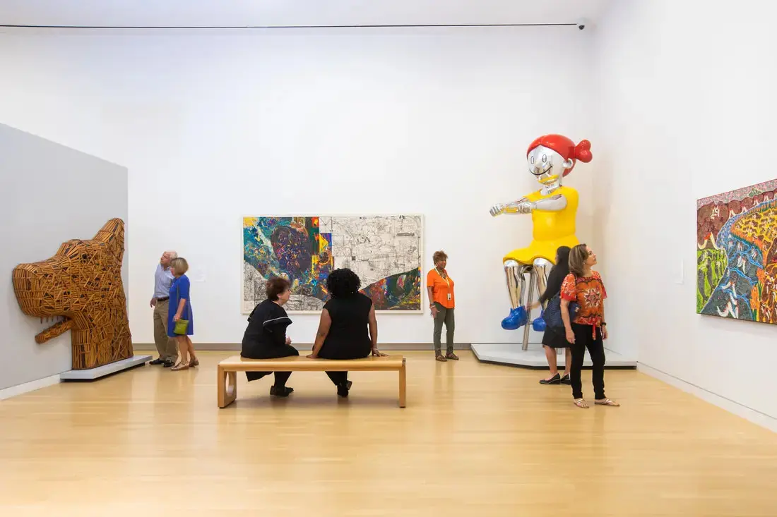 People looking at the art works displayed inside the museum