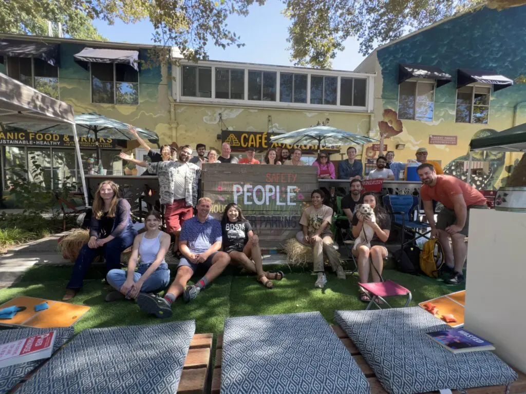 Strong SacTown volunteers and attendees gather in Sacramento in September 2024 to create an outdoor pop-up parklet as part of the global event, Park(ing) Day. 