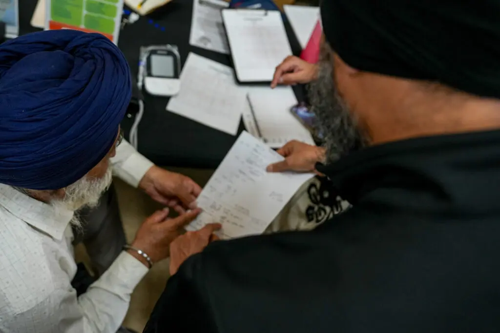 Dr. Swaiman Singh, UC Davis professor and 5 Rivers Heart Association founder, talking to a patient at Gurdwara Sri Sachkhand Sahib, a Sikh temple on 1090 Main St. in Roseville.