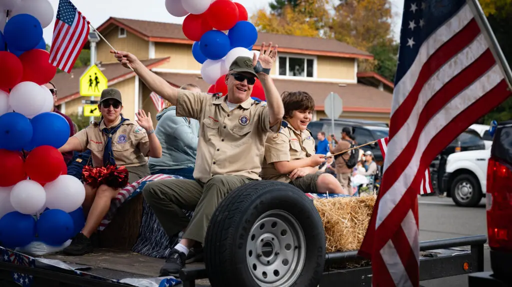 people on a float waving