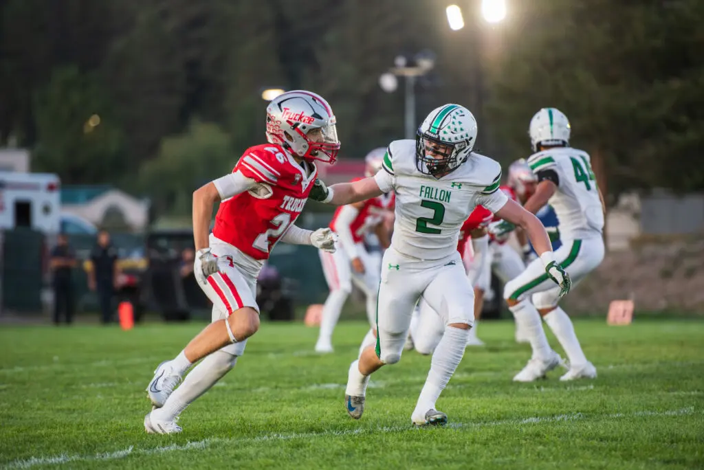 Two people playing football