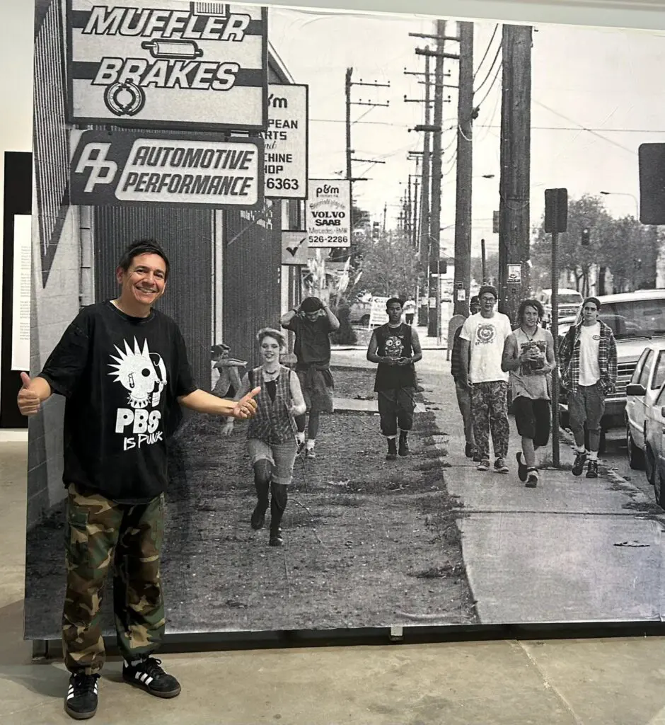 Chris Macias at "Hail Murray" event wearing a PBS is Punk t-shirt.