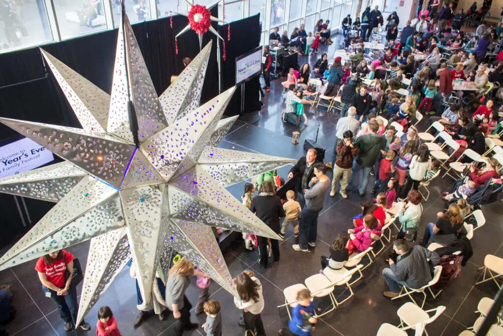 A crowd gathers under a ball