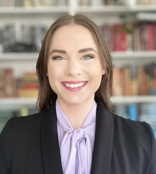 College professor posing and smiling.
