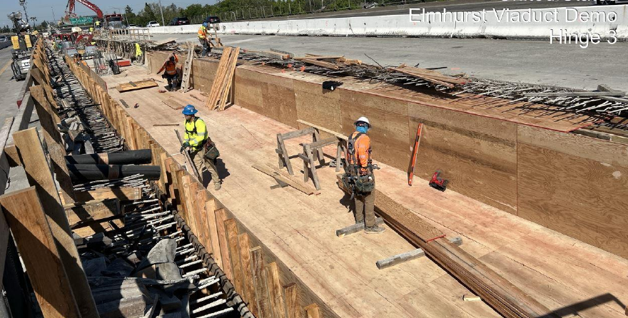 Construction workers surrounded by plywood