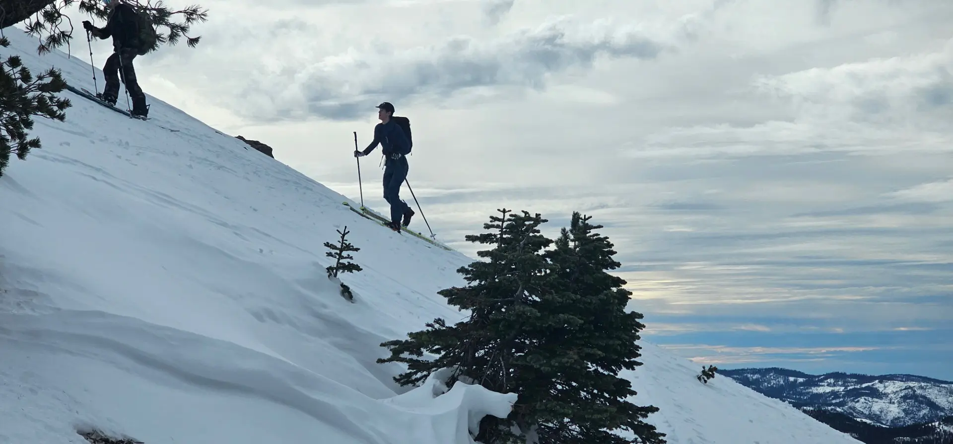 Man walks up a snowy mountain