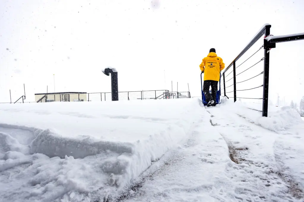 Worker clears snow at a resort