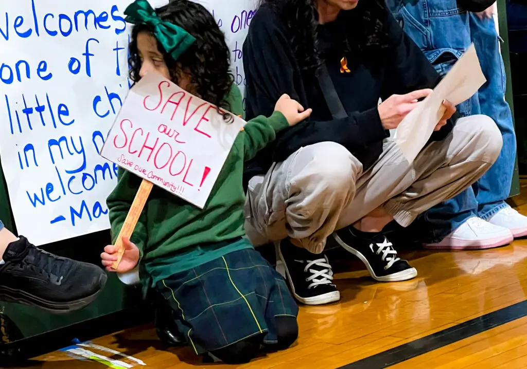 A student holds a sign