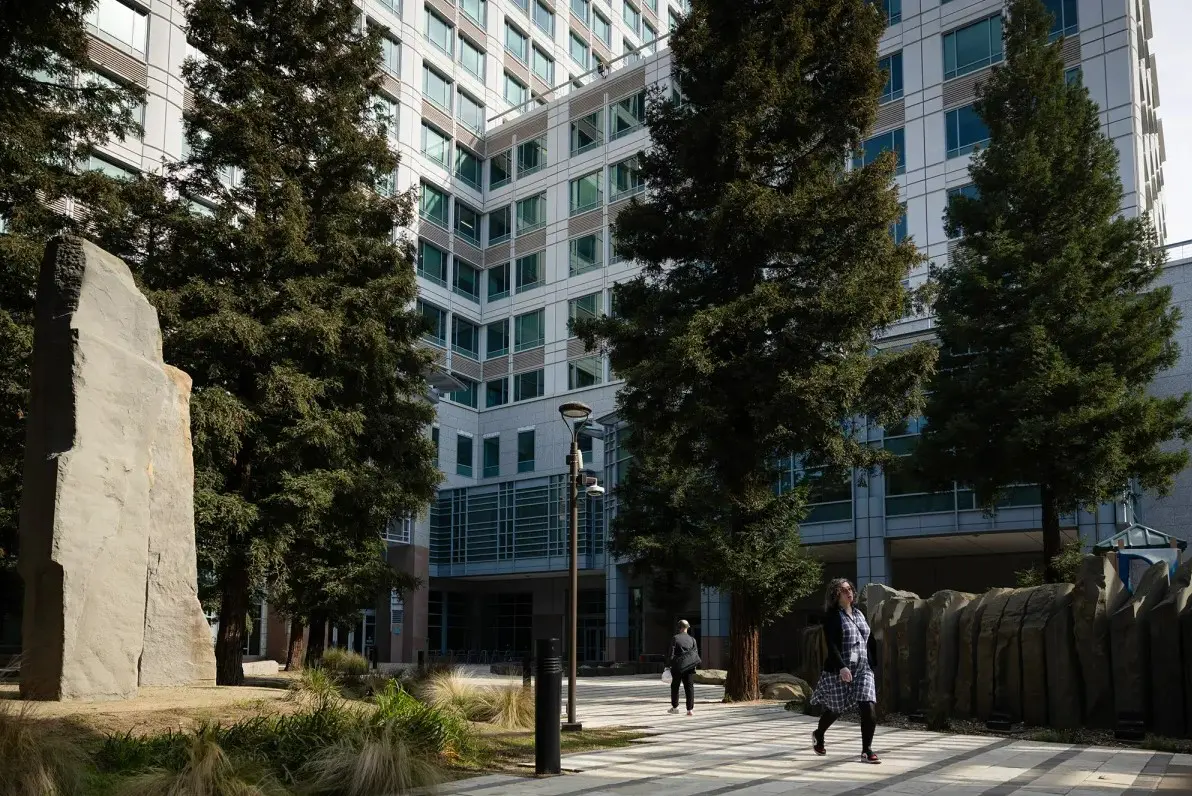 A woman walks in front of the offices of the California Environmental Protection Agency.