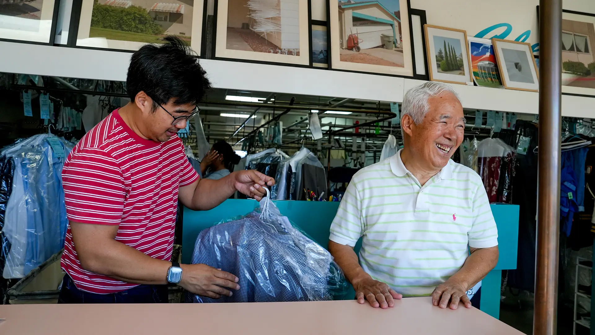 Enoch Ku and his father, Ha Wan Ku, chat with customers at Vogue Cleaners in Sacramento's Arden Arcade neighborhood. Photo by Denis Akbari.