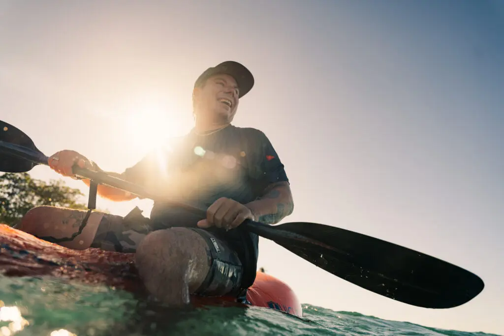 Roy Tuscany with a double-sided paddle on the water