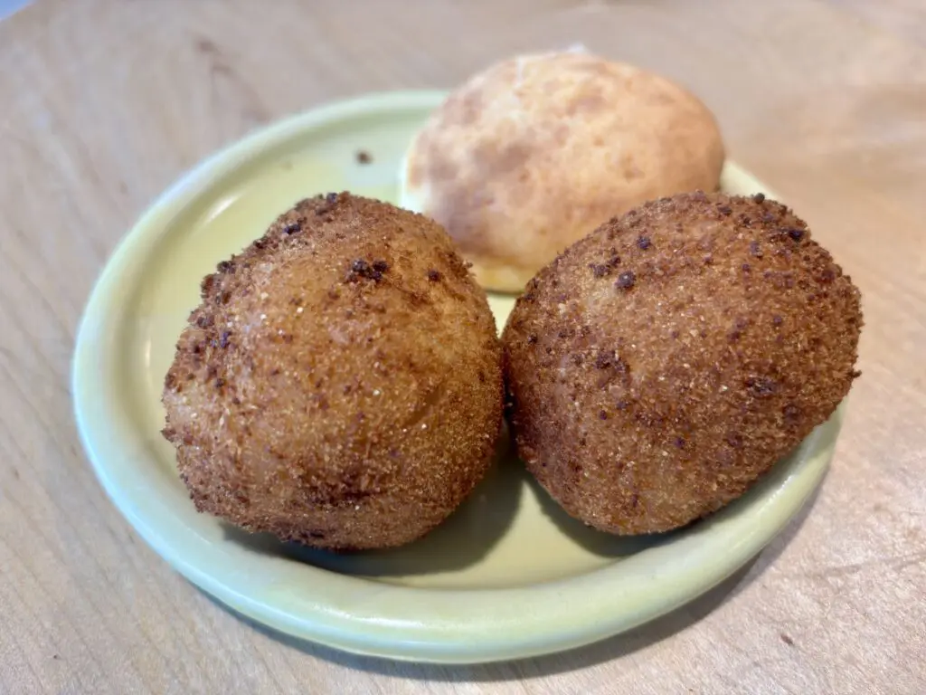 Clockwise from left: coxinha, pão de queijo and rissoles.