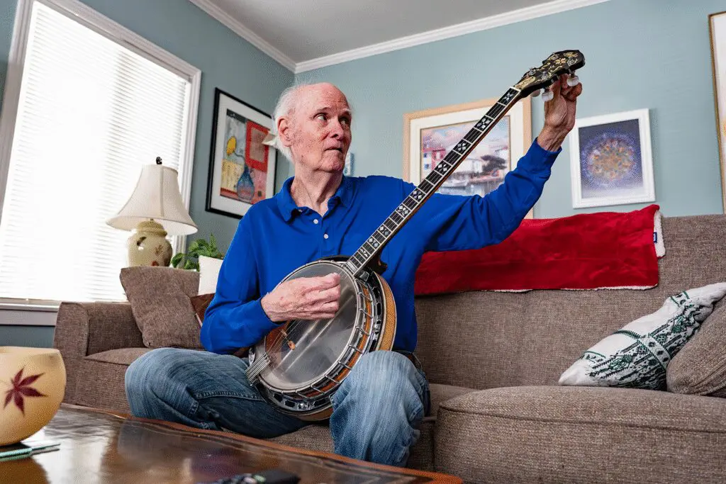 person tuning banjo