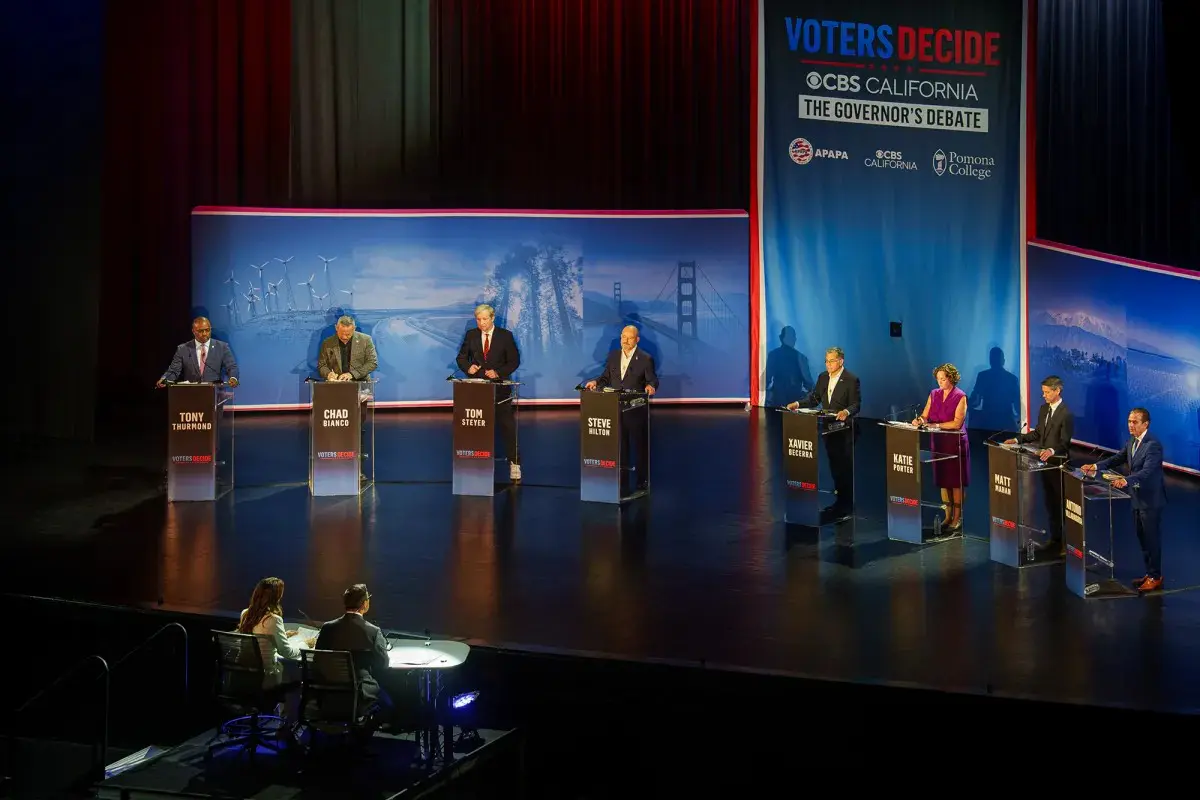 From left, candidates Tony Thurmond, Chad Bianco, Tom Steyer, Steve Hilton, Xavier Becerra, Katie Porter, Matt Mahan and Antonio Villaraigosa stand on stage for the CBS California Gubernatorial Debate at Bridges Auditorium on the campus of Pomona College in Claremont on April 28, 2026.