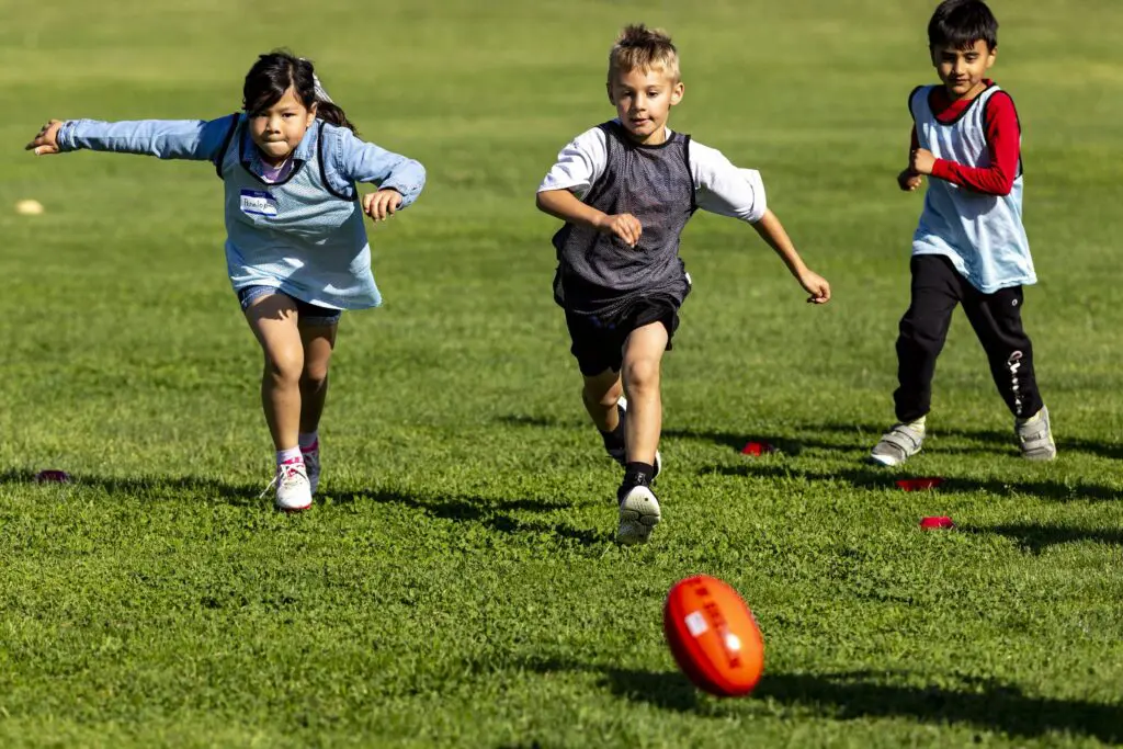 Kids play Australian football