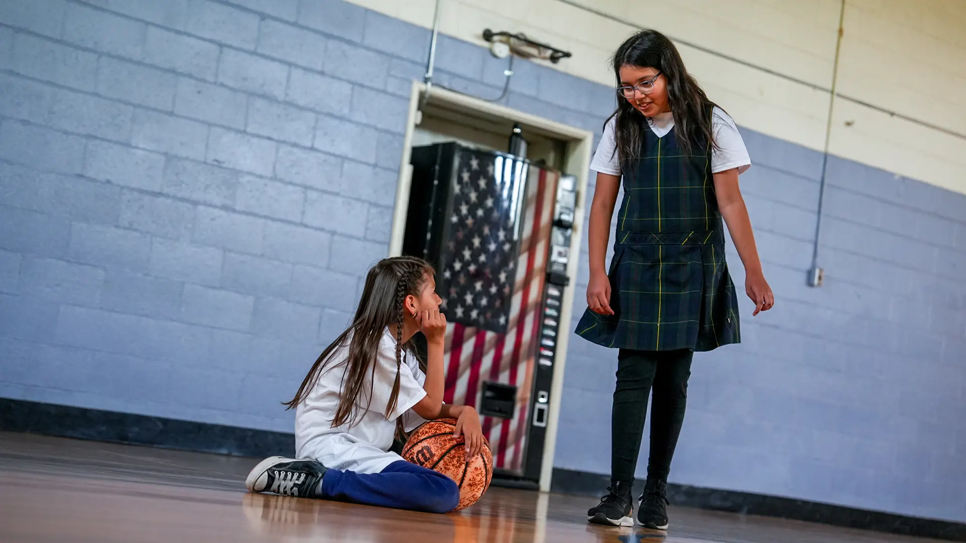 Kenya Negrete and Alessandra Reading playing basketball at the Village Church. Photo by Denis Akbari.