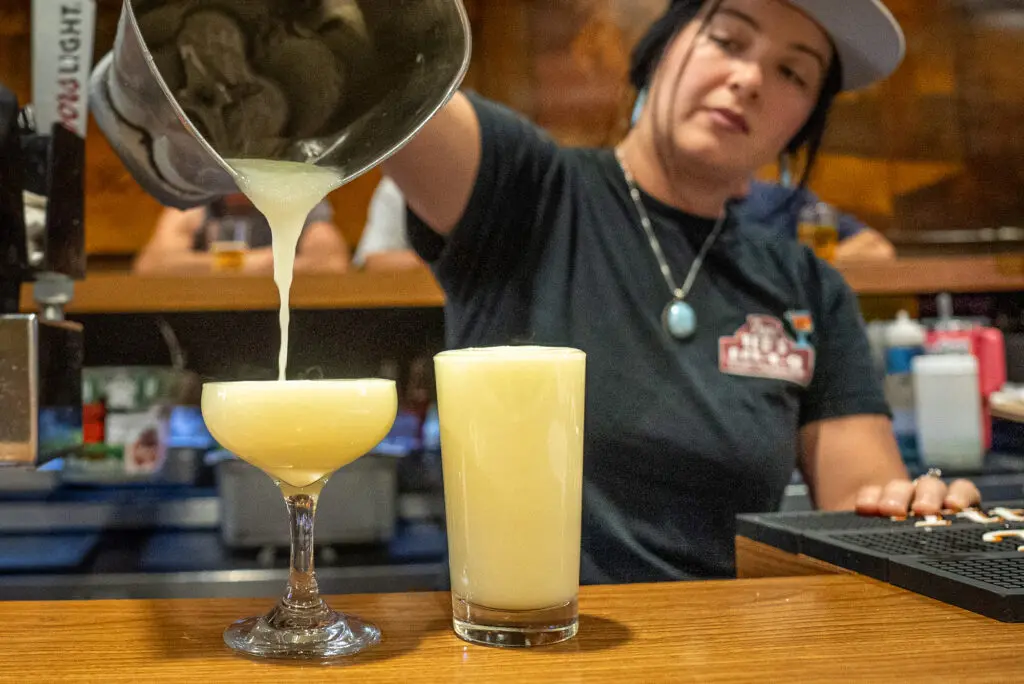 cocktail server pouring drink