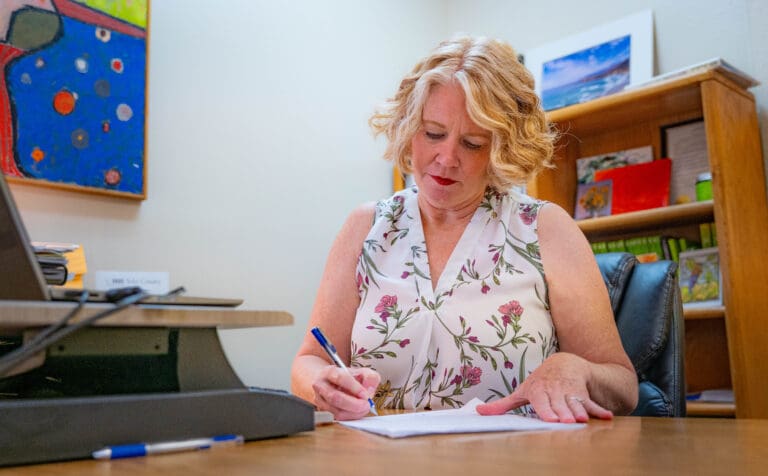 Jen Boschee-Danzer, executive director of NAMI Yolo County, works in her office in Woodland on Monday, Sept. 29, 2025