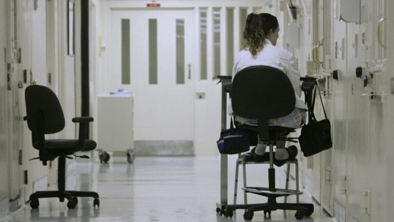 In this March 30, 2008 file photo, medical worker Theresa Wilks keeps a vigil outside an isolation cell containing an inmate who authorities fear might attempt suicide, at California State Prison - Sacramento in Folsom.