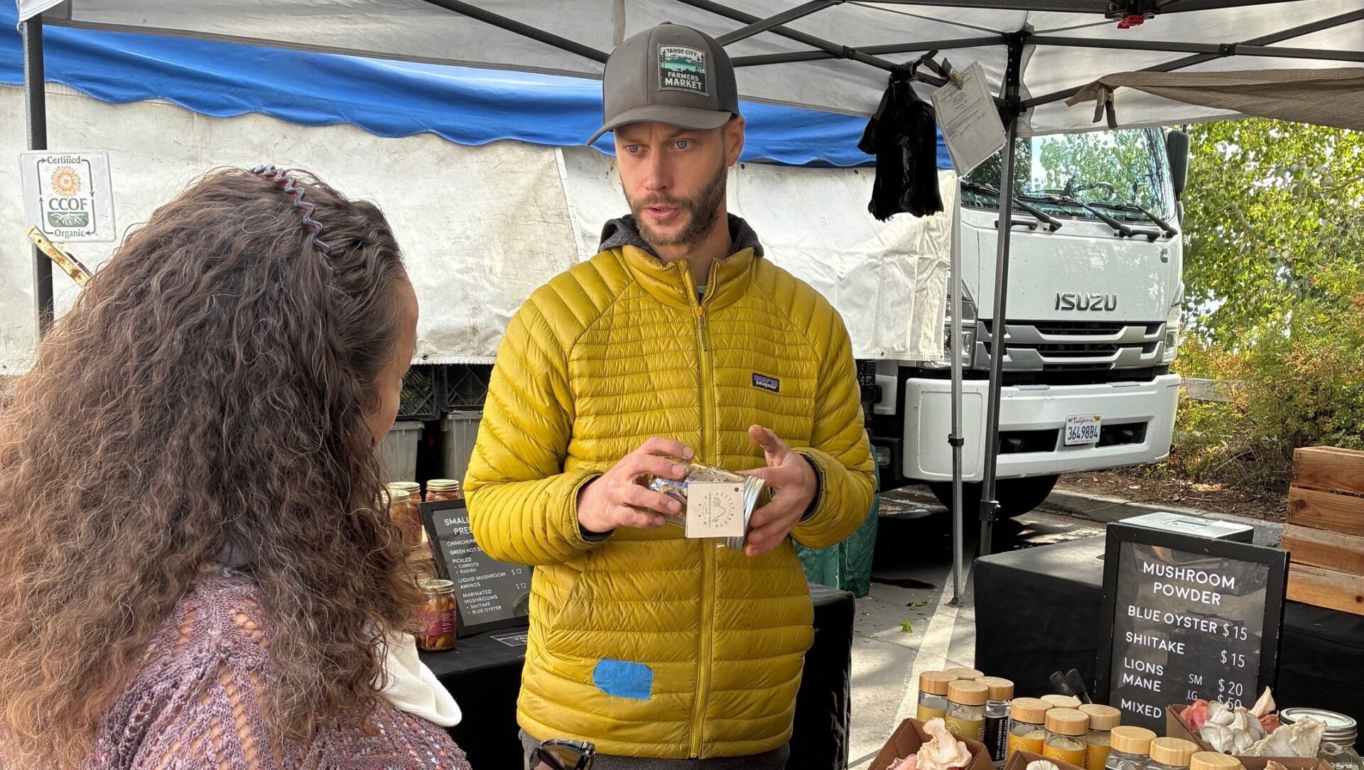 Todd Karol of Little Roots Farm speaks to a customer at the Tahoe City Farmers' Market.