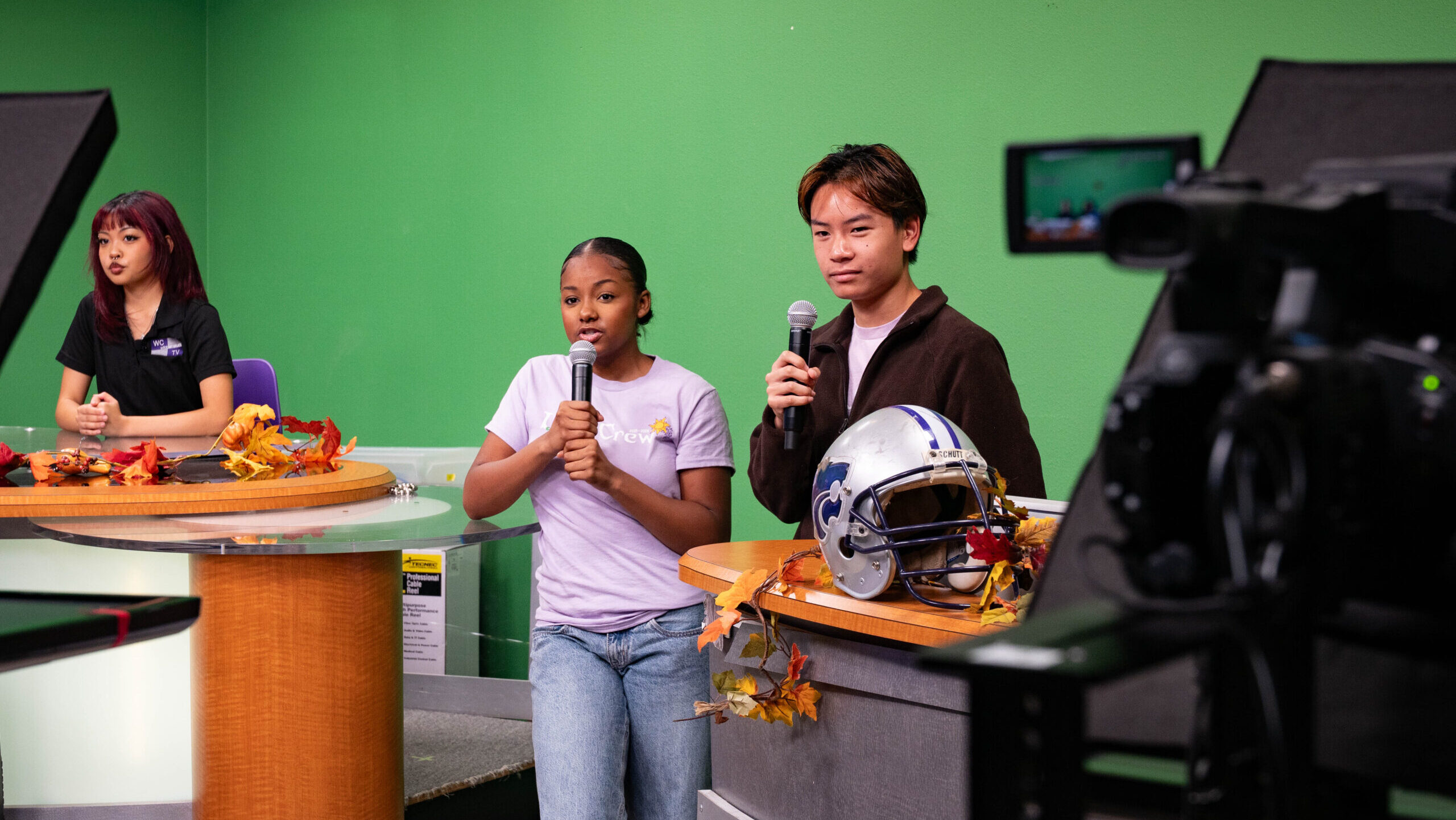 Syndie Taylor, middle, and Matthew Nguyen, right, rehearse for the WCTV Morning Bulletin at Franklin High School in Elk Grove on Tuesday, Oct. 7, 2025.