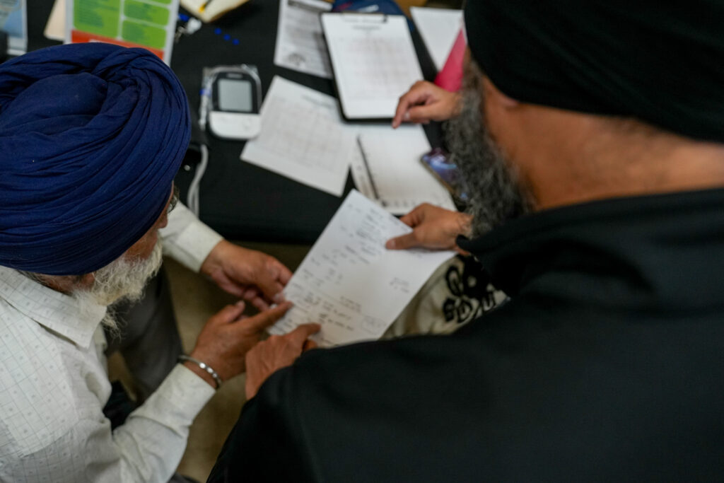 Dr. Swaiman Singh, UC Davis professor and 5 Rivers Heart Association founder, talking to a patient at Gurdwara Sri Sachkhand Sahib, a Sikh temple on 1090 Main St. in Roseville.