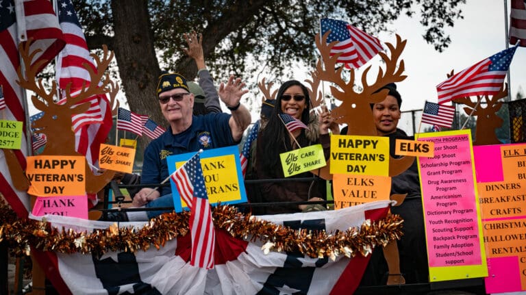 people waving on a float