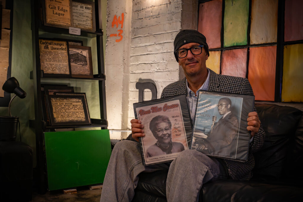 man holding two binders