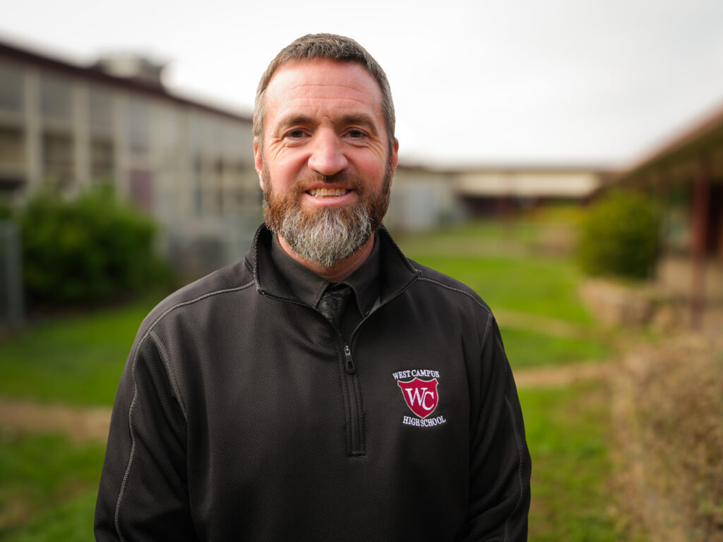 Principal standing outside school