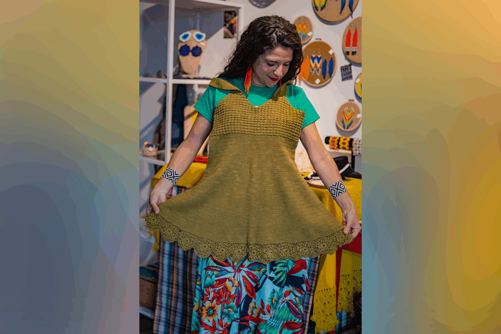 woman holds up dress