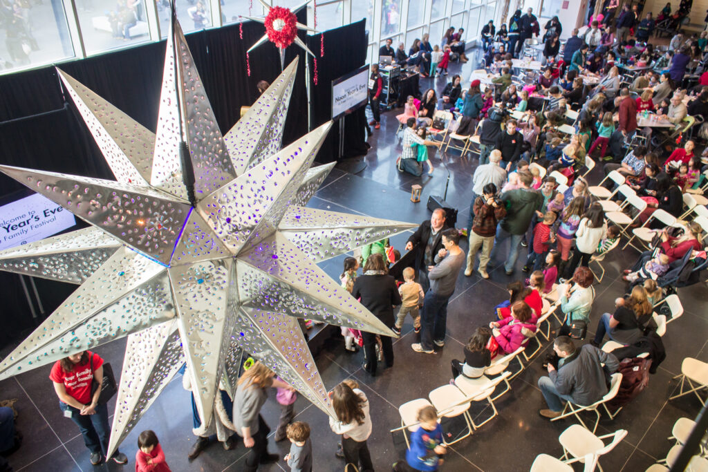 A crowd gathers under a ball