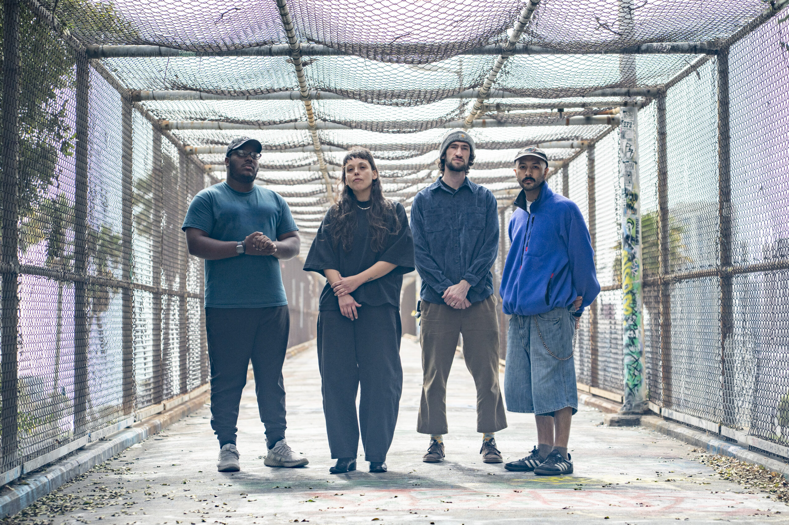 A band poses on a bridge
