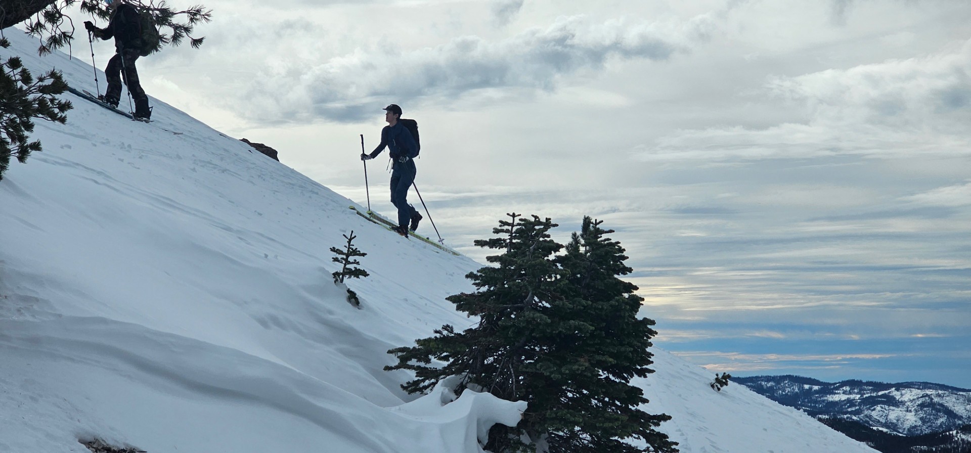 Man walks up a snowy mountain
