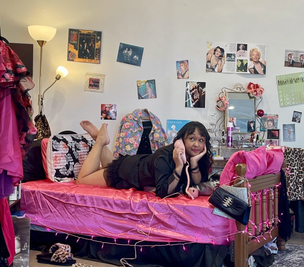 Angela Dee Alforque relaxes in her bedroom-themed installation, "Fast Girls In Parked Cars," at Prism Art Space.