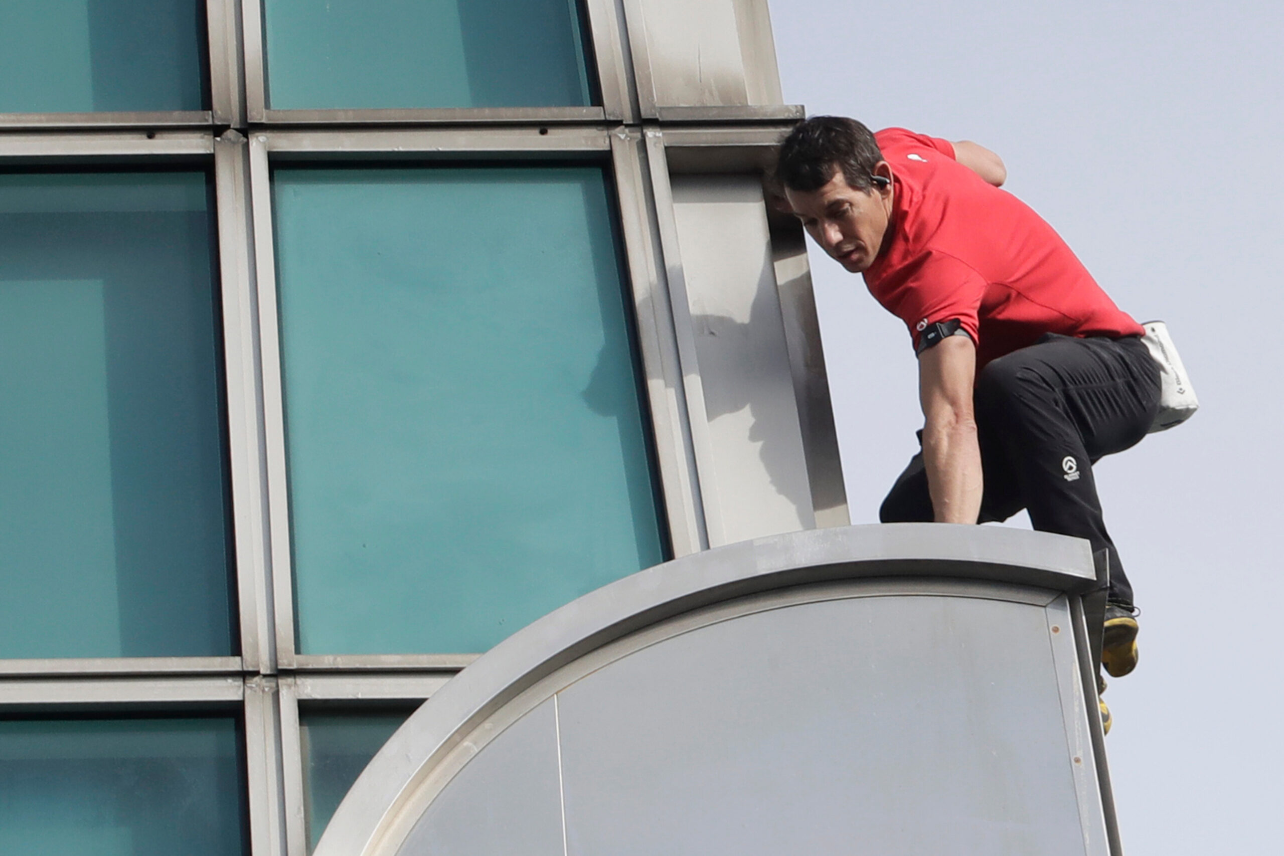 A man climbs a skyscraper