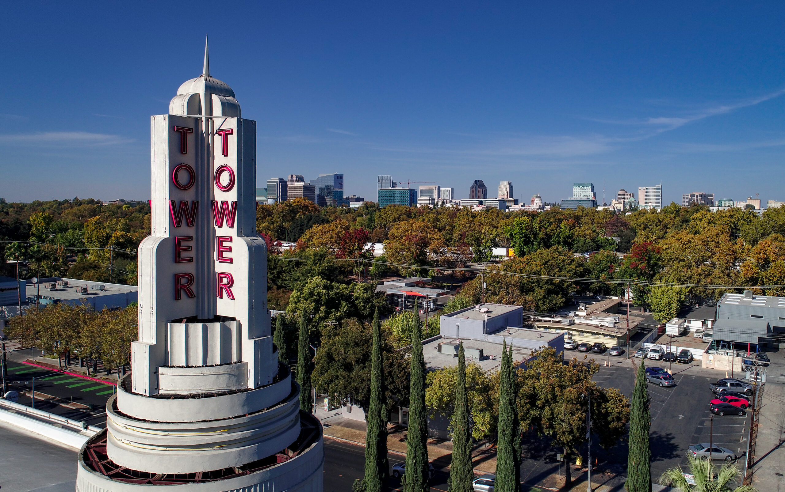 Tower theater with trees in background and skyline