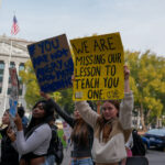 Student holds a sign