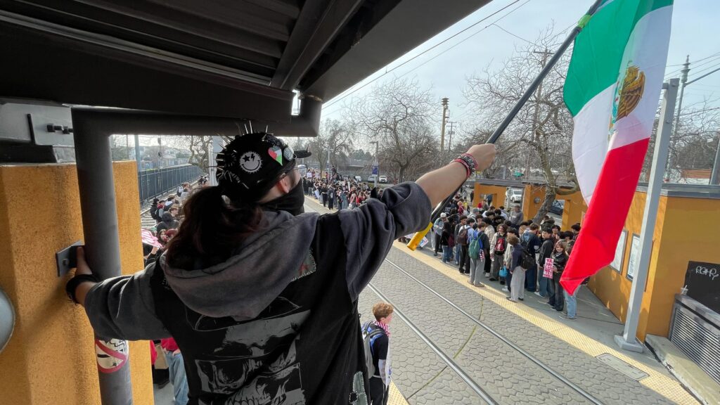 Student at a light rail station
