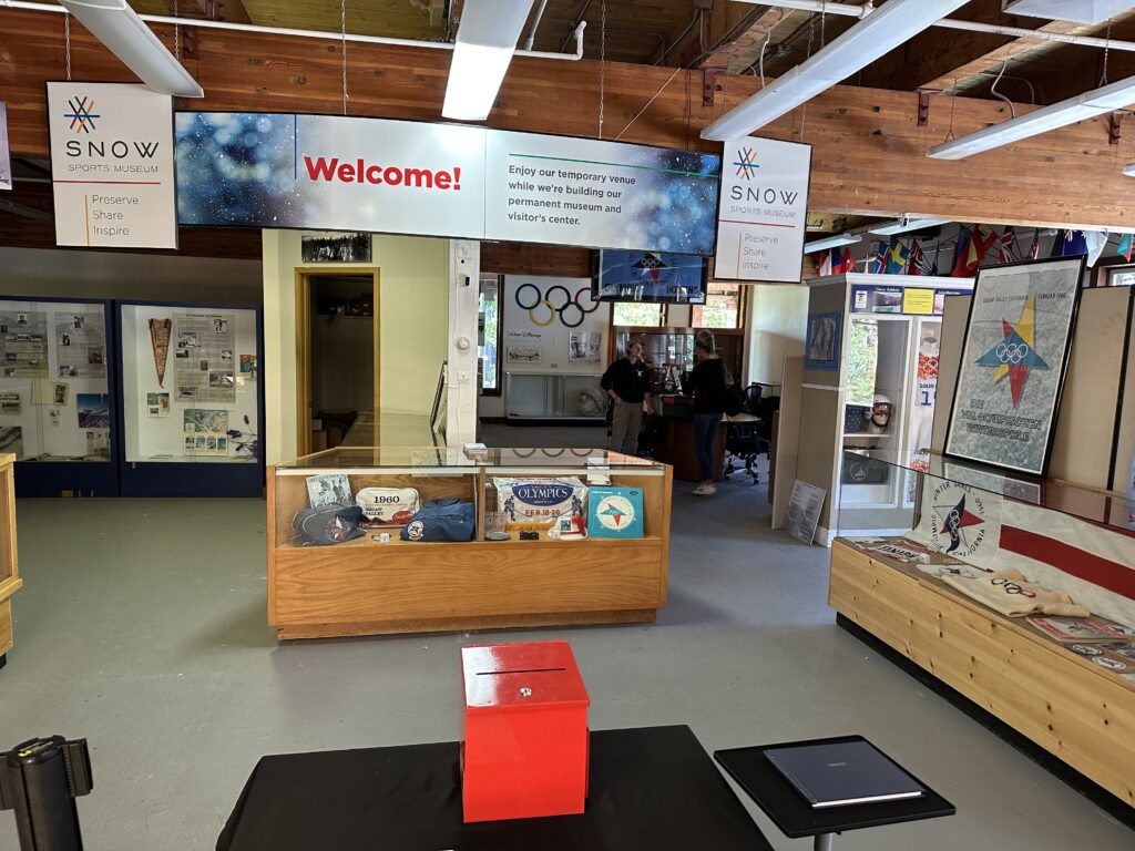 A welcome sign at SNOW Sports Museum, a one-room exhibit with 1960 Olympics memorabilia