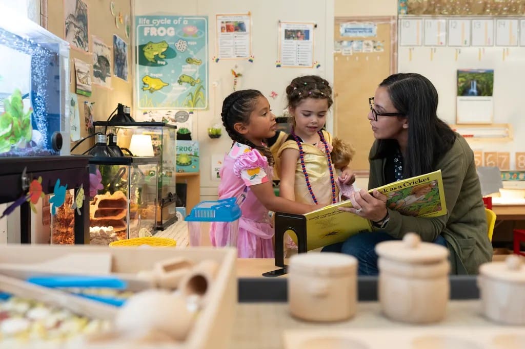 Transitional kindergarten instructional assistant Nancy Espino reads a book about crickets to children at Silverwood Elementary School in the Mt. Diablo Unified School District in Concord on Aug. 11, 2025.