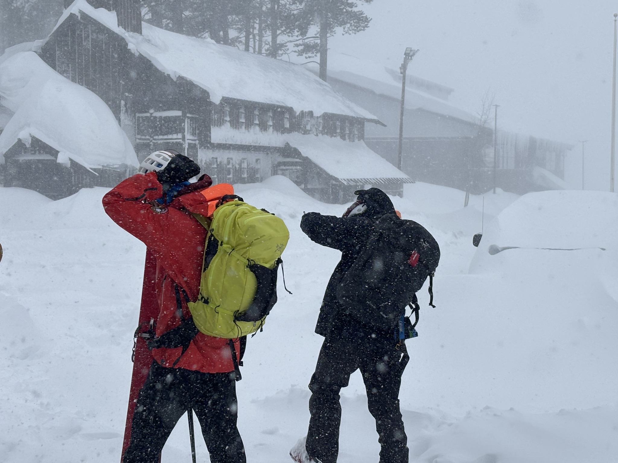 Two men in ski gear in a blizzard