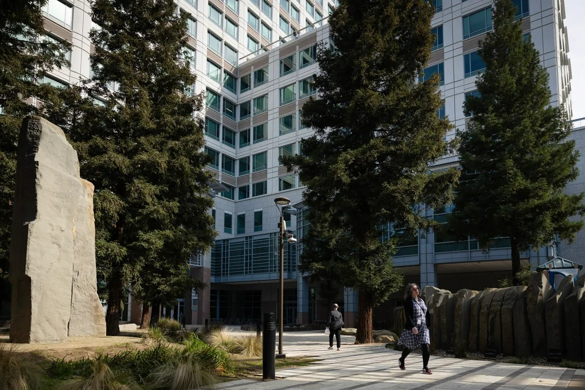 A woman walks in front of the offices of the California Environmental Protection Agency.