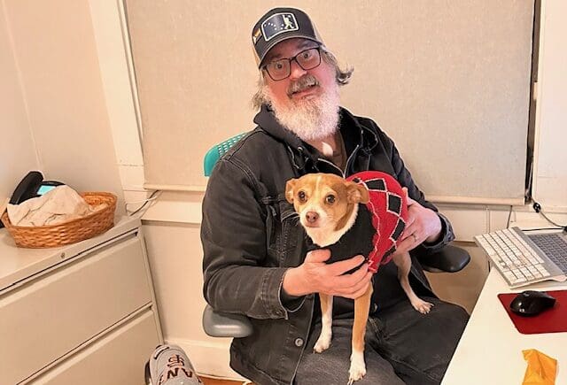 man holds dog