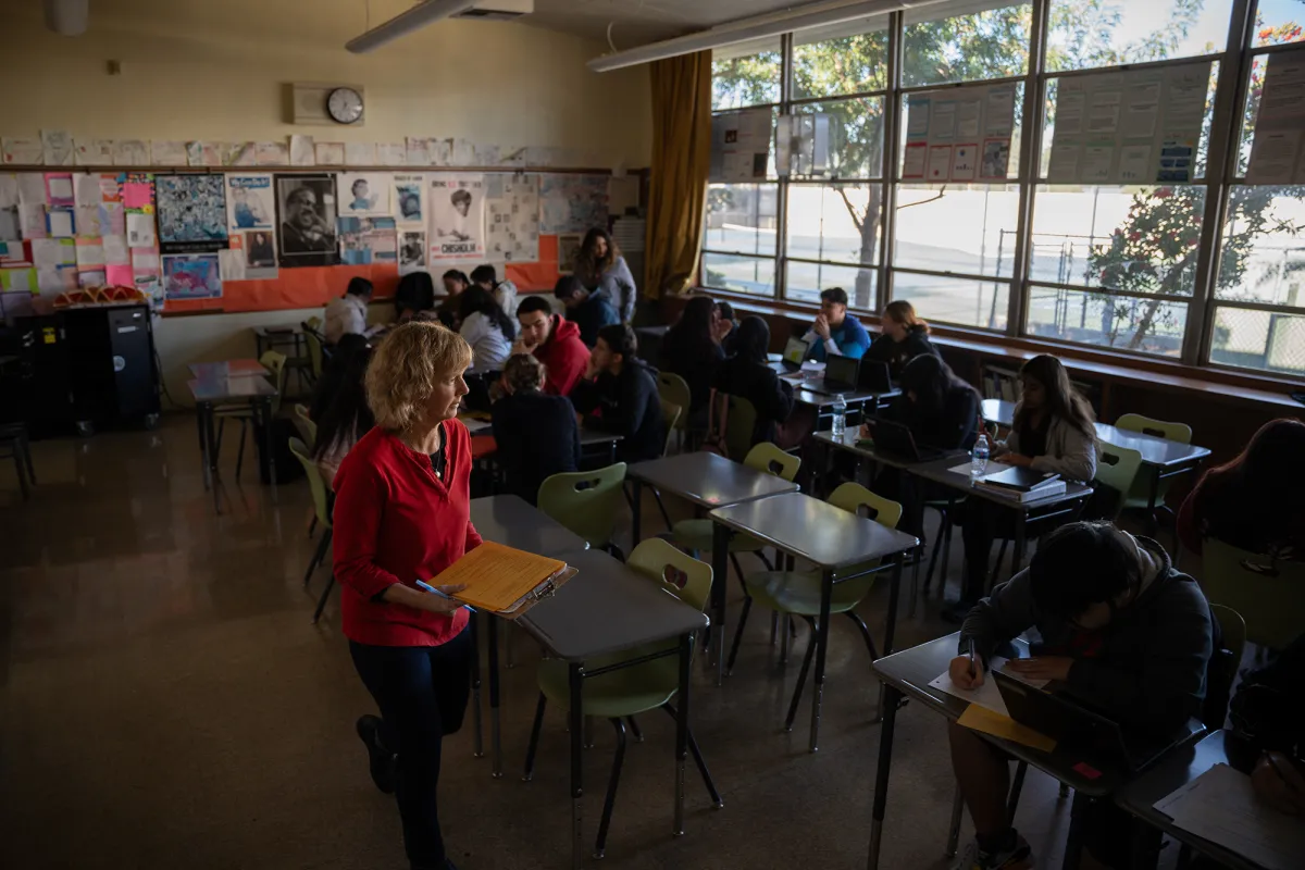 San Lorenzo High School teacher Judy Smith teaches her third period government class in San Lorenzo on Dec. 3, 2024, as they develop civic action infographics on topics ranging from gun violence to vaping. Smith’s students will submit their final projects to the KQED Youth Media Challenge which will publish the infographics online to share how students see themselves, their world and their future.