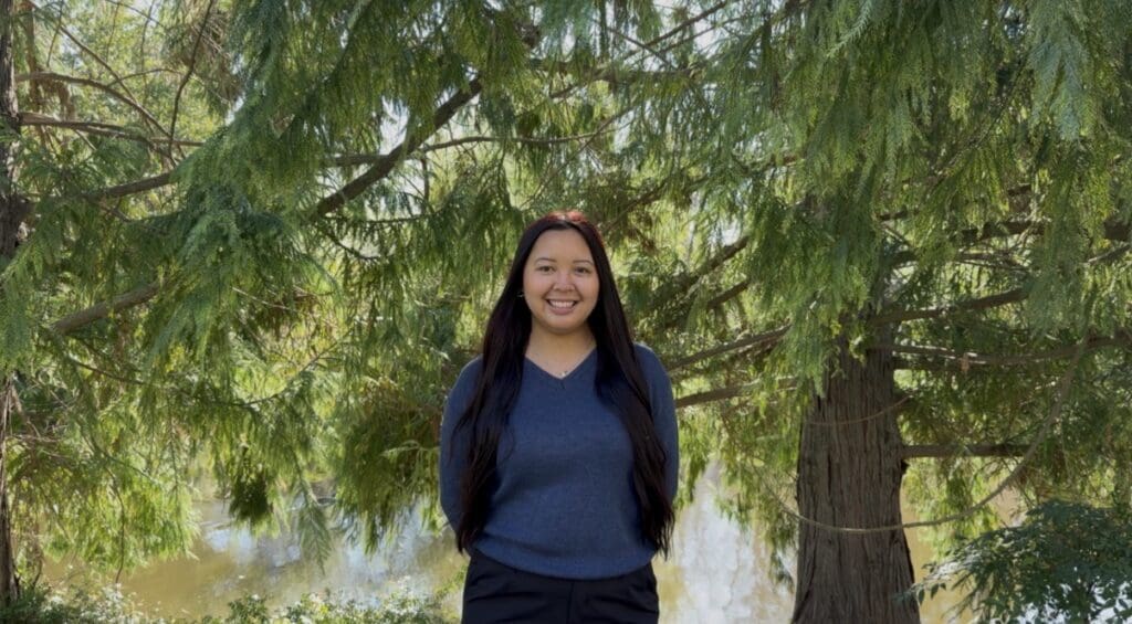 Woman stands in trees