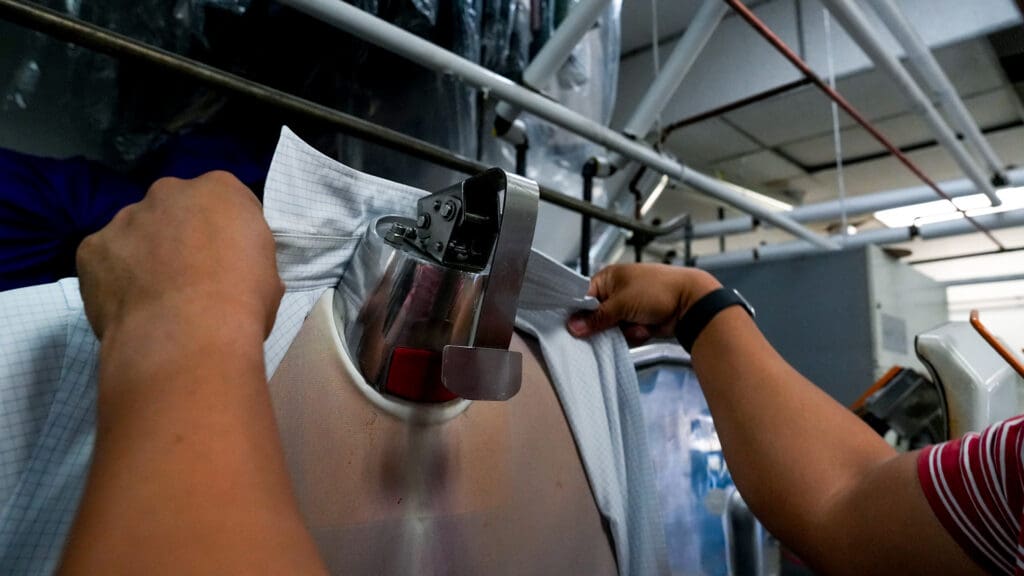 Enoch Ku working at Vogue Cleaners, his family business. Photo by Denis Akbari.