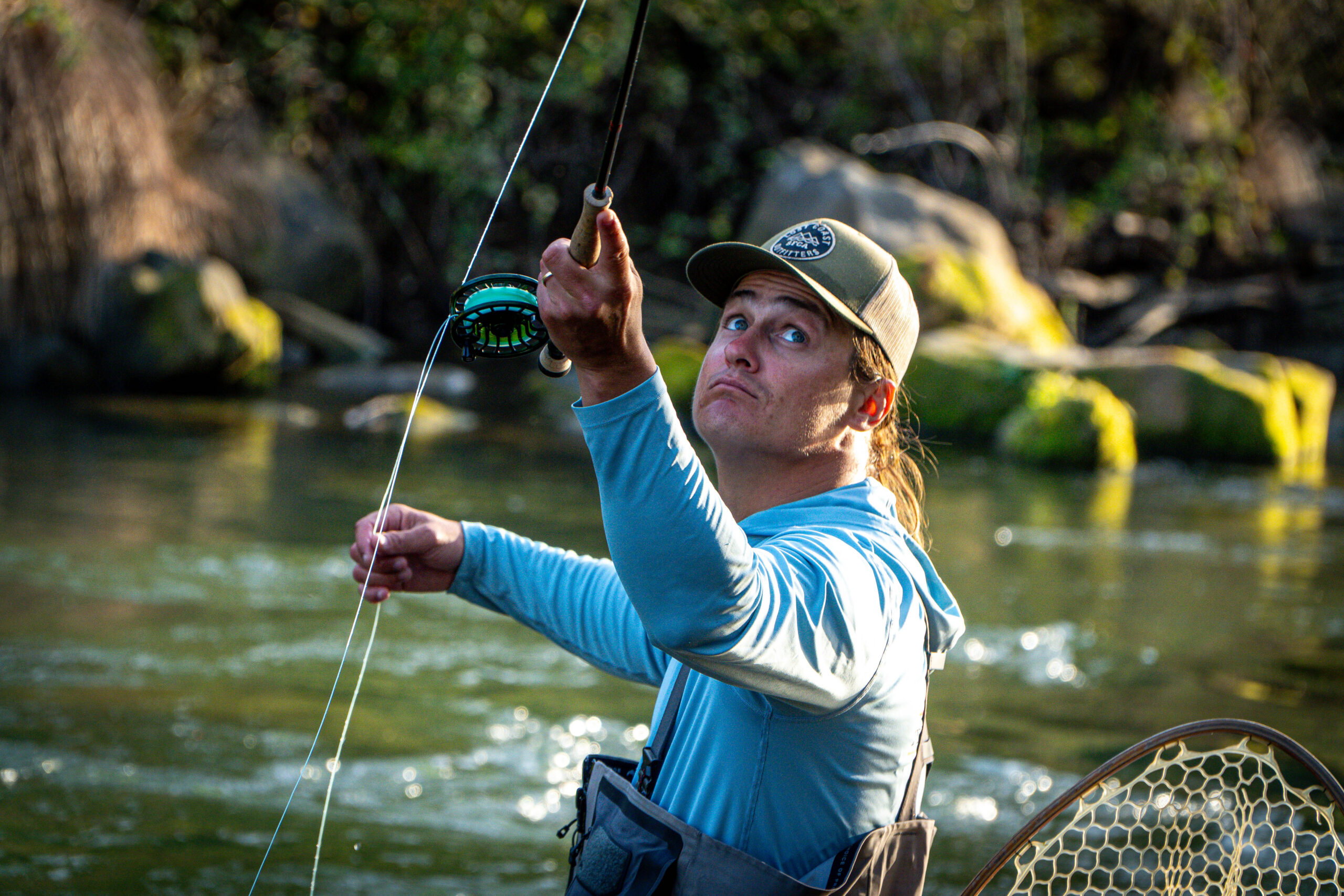 Fly Fisherman casting in creek