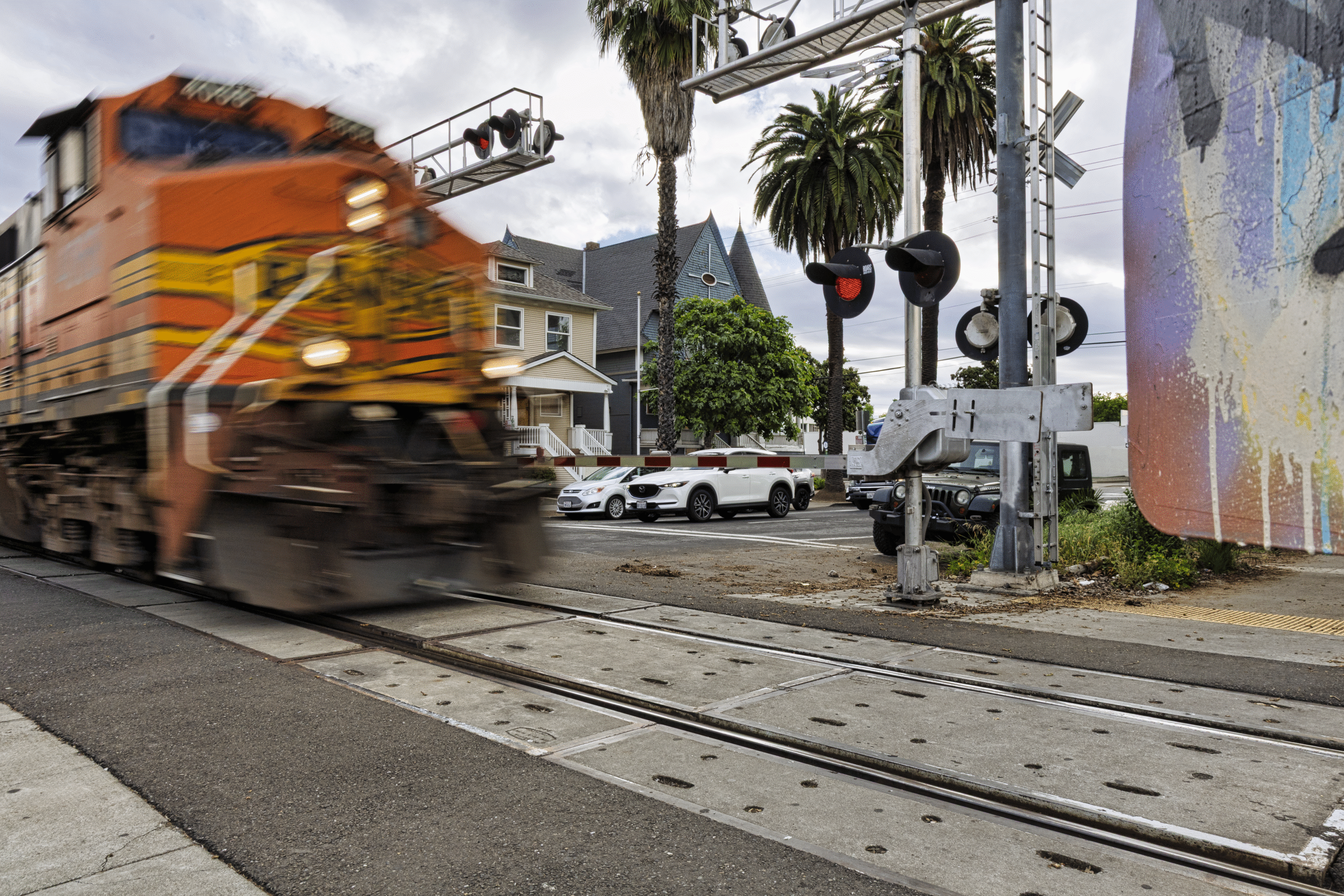 Railroad crossing with train and cars