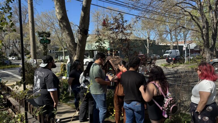 People gathered on the sidewalk.