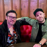 Two men sit in a booth